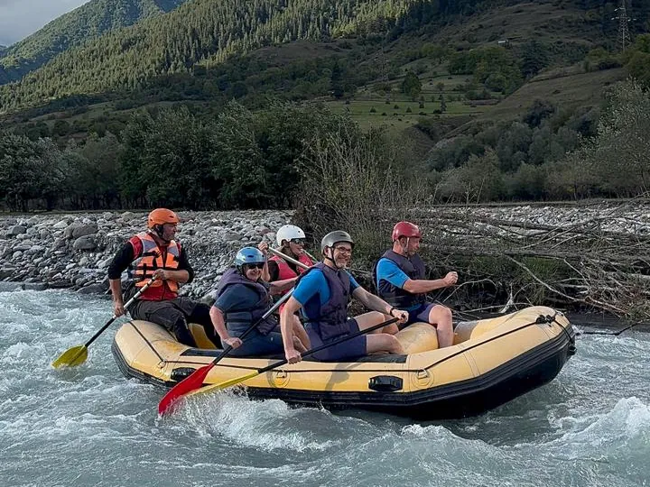 Crew paddling hard through rapids on the extreme rafting route