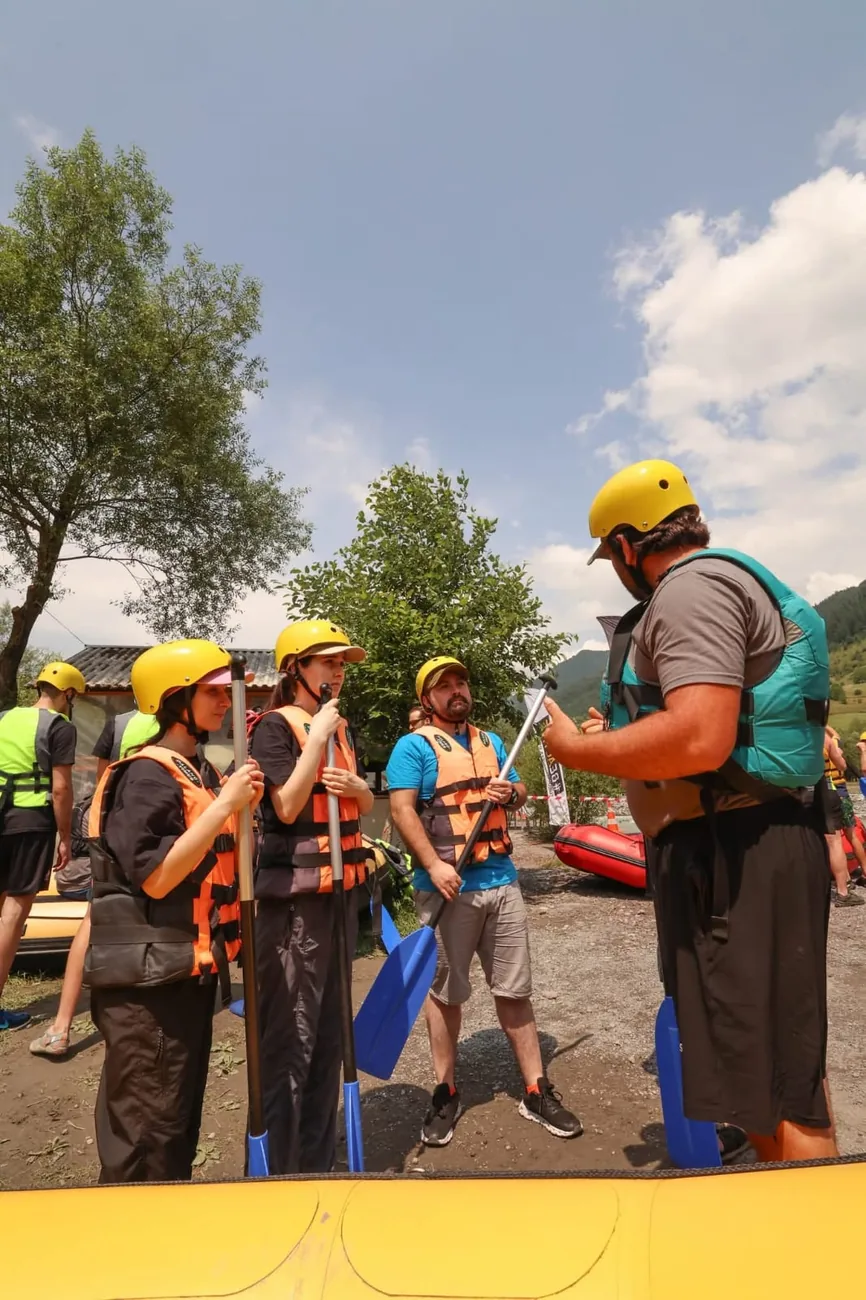 Guide briefing a small group with paddles before launch